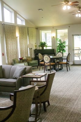 Bright common area with comfortable seating and dining tables