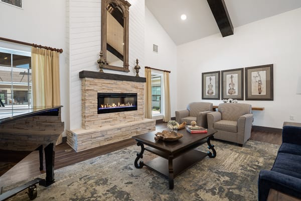 Bright common area with seating and fireplace