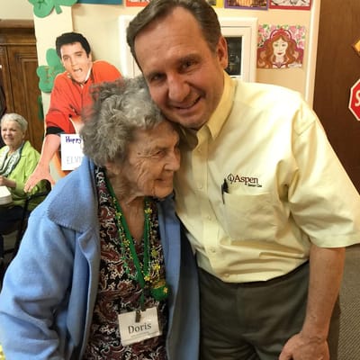 Resident embracing staff member in an activity room