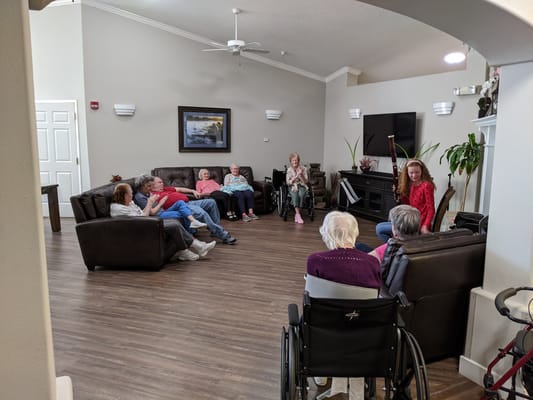 Residents and staff in a common area engaging in an activity
