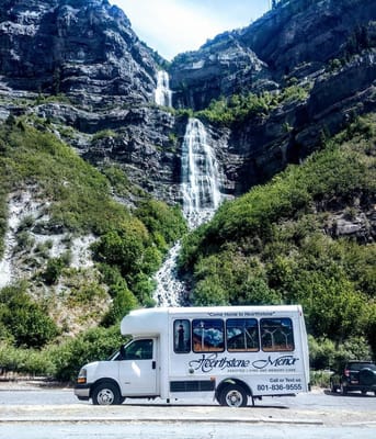 Facility shuttle bus parked with a scenic backdrop