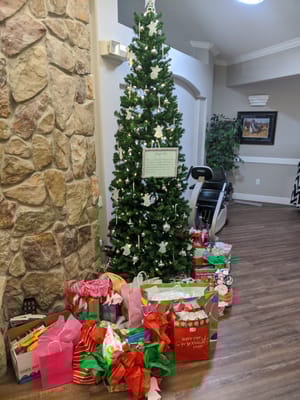 Christmas tree with wrapped gifts in a common area