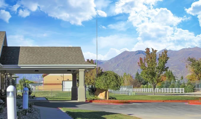 Exterior view of Hearthstone Manor with mountains in background