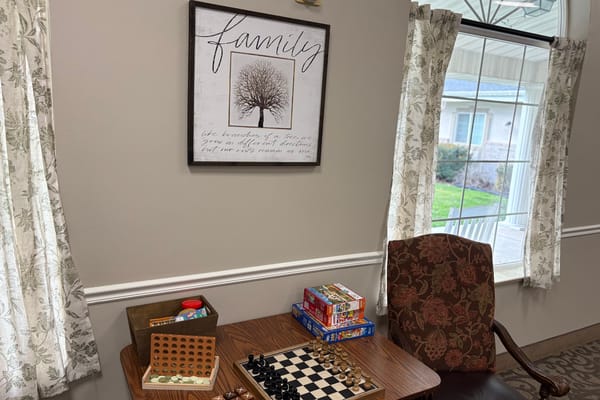 Cozy common area with a game table and family-themed decor