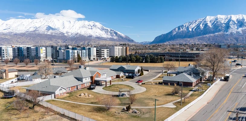 Aerial view of Lake Ridge Senior Living facility with mountains