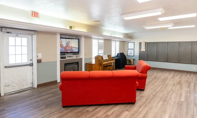 Interior view of a common area with seating and a piano