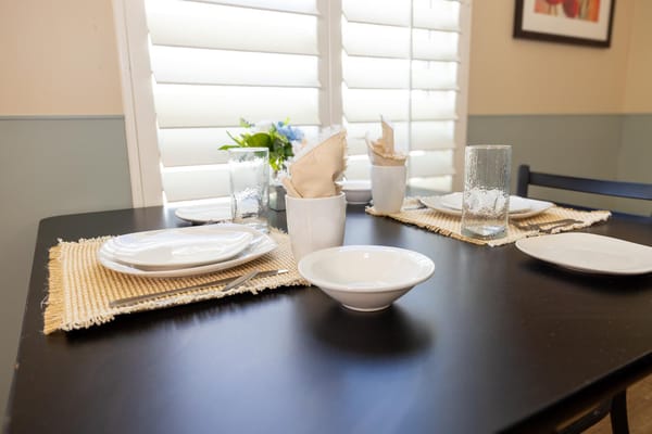 Dining table set with plates and glasses