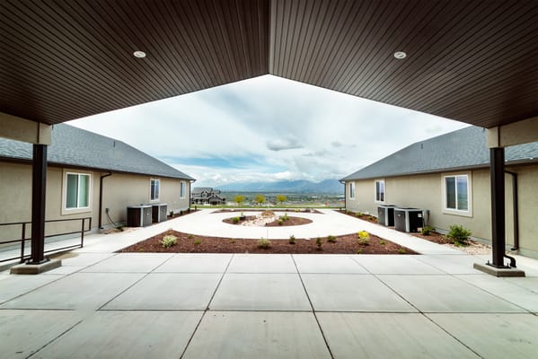 Outdoor courtyard with landscaped garden and mountains