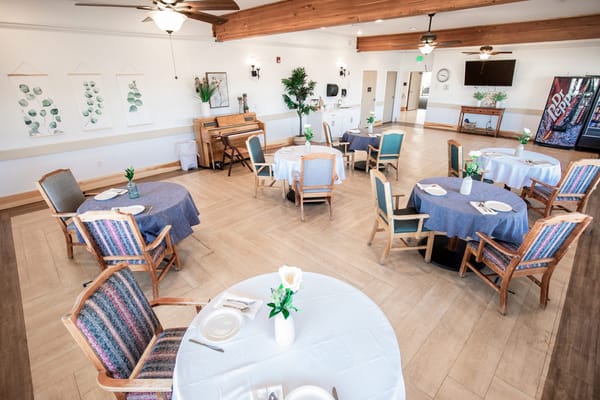 Dining room setup with tables and chairs