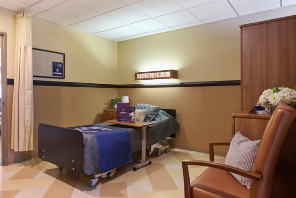 A cozy resident room with a bed and seating