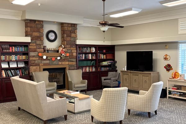 Common area with seating and bookshelves in a cozy setting