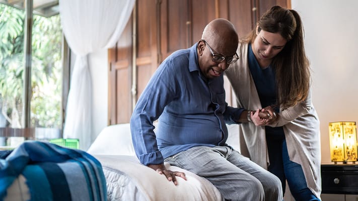 Staff assisting a resident in a cozy room