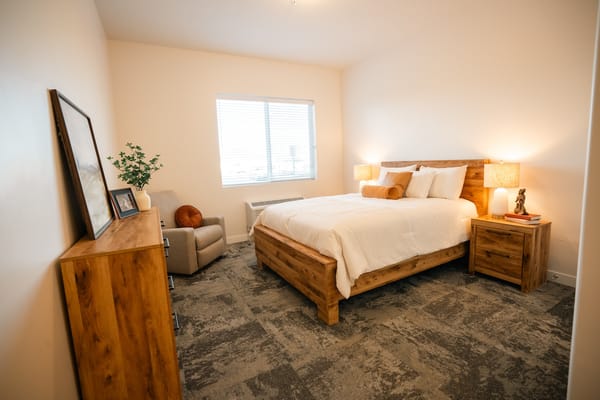 Cozy private bedroom with wooden furniture