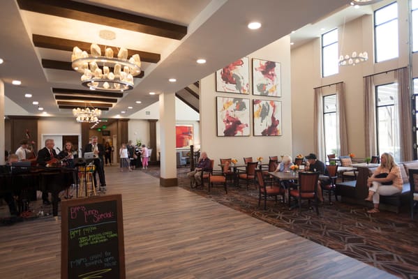 Bright common area with residents and staff engaging