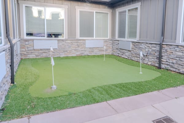 Outdoor putting green with flags at a senior living facility