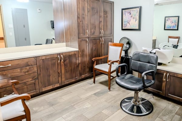 Hair salon interior with styling chairs and cabinets