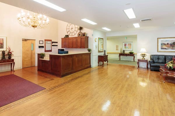 Bright interior common area with wooden flooring and seating