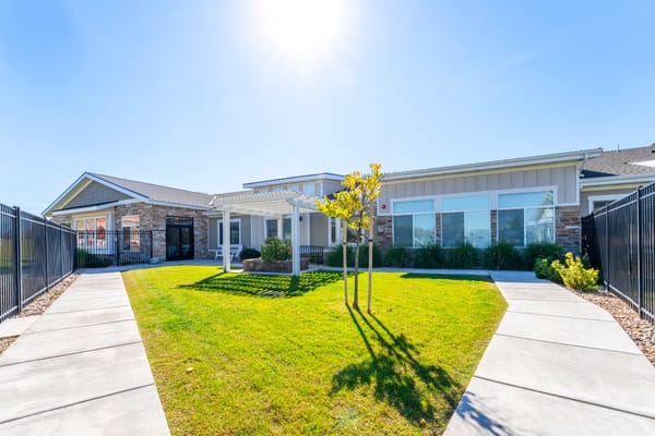 Exterior view of Sunridge Assisted Living with landscaping