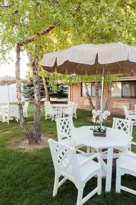 Outdoor seating area with tables under a tree