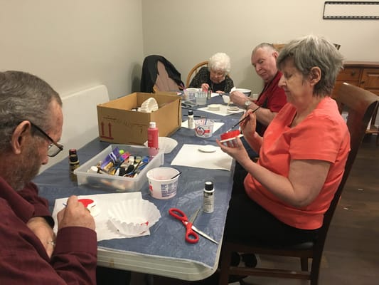 Residents engaging in a craft activity at a table