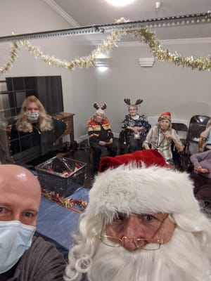 Residents enjoying a holiday celebration with Santa