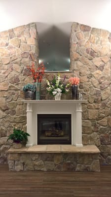 Decorative stone fireplace with flower arrangements
