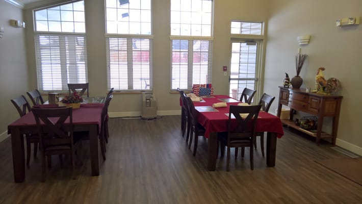 Dining area with tables and chairs set for meals