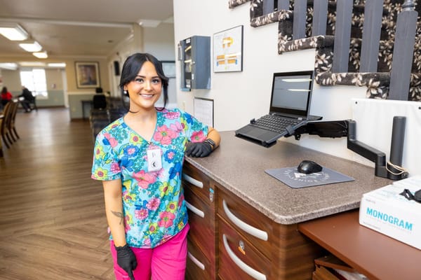 Staff member smiling in a well-lit common area