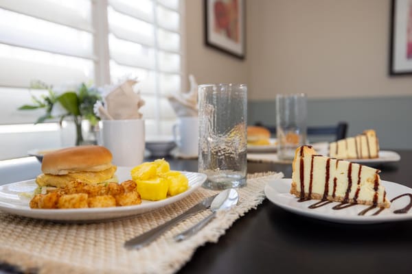 Breakfast spread with eggs, potatoes, and cake