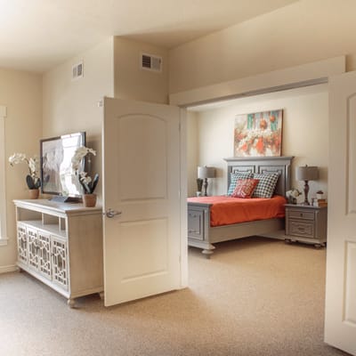 A cozy private resident room with a bed and furniture