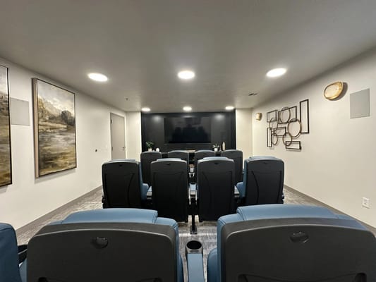 A movie theater room with plush seating