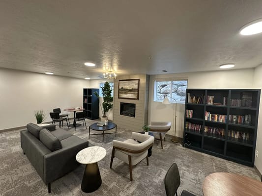 Interior common area with seating and bookshelves