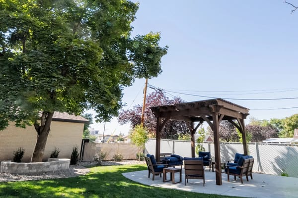 Outdoor seating area with shaded gazebo and chairs