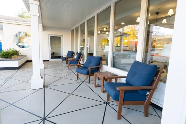 Seating area outside a common space with blue chairs