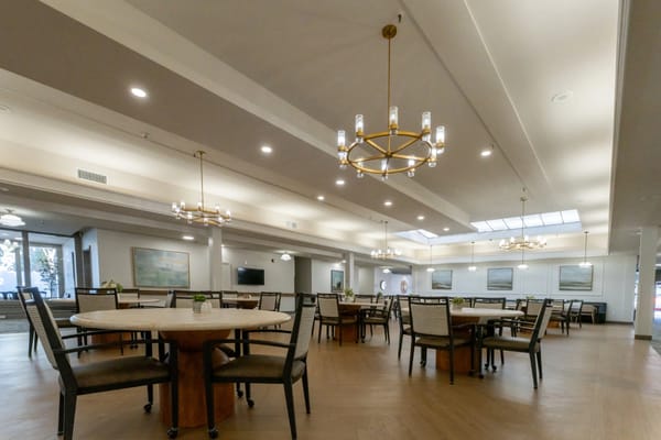 Interior view of a common dining area with tables and chairs