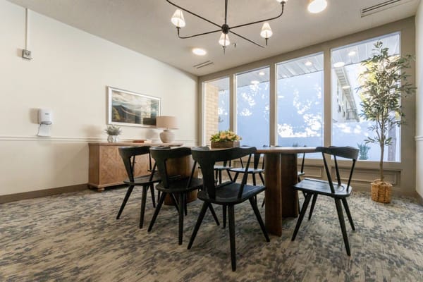 Bright common area with a spacious table and chairs