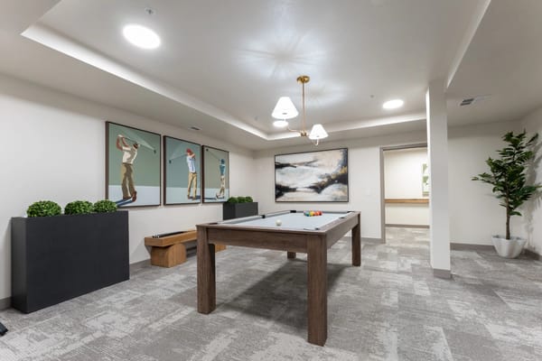 A common area with a billiards table and artwork