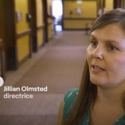 Director speaking in a facility hallway