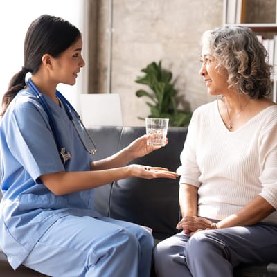 A caregiver interacting with a resident in a cozy setting