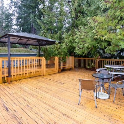 A wooden outdoor deck area with seating