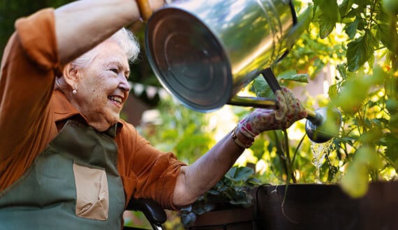Senior resident gardening with a watering can