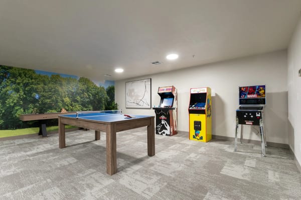 Game room with pool table and arcade machines