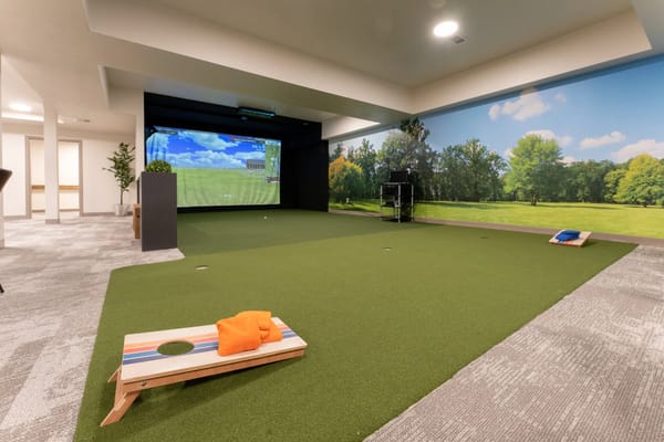 Indoor putting green with a scenic backdrop