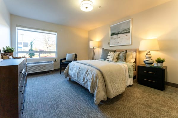 A cozy resident room with a bed and window