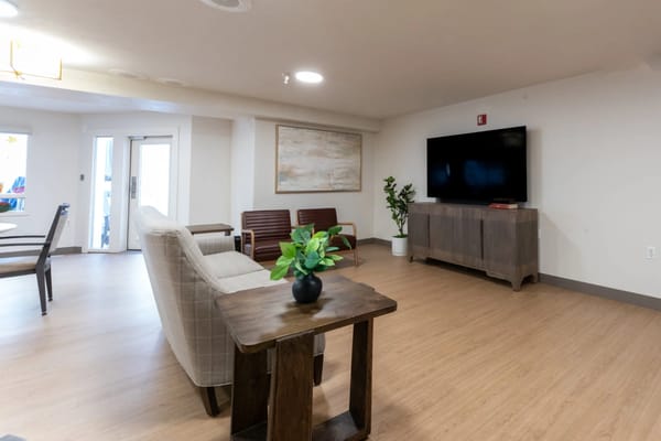 Bright common area with seating and TV