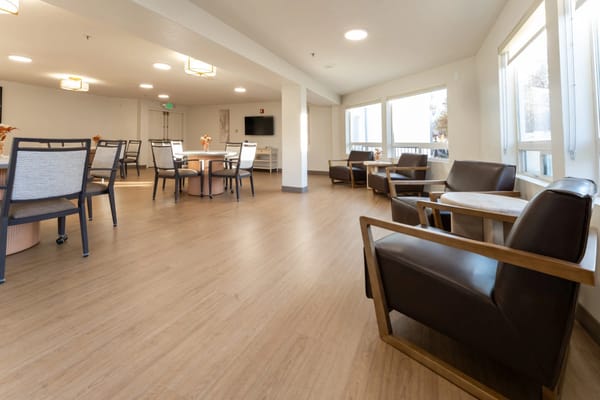 Bright common area with seating and tables