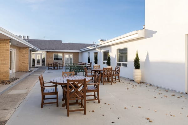 Outdoor courtyard with wooden tables and chairs
