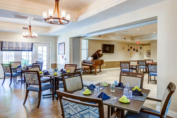 Bright dining room with tables set for meals