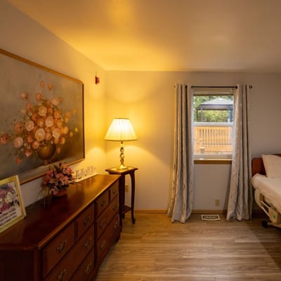 Cozy resident room with floral decor and window view