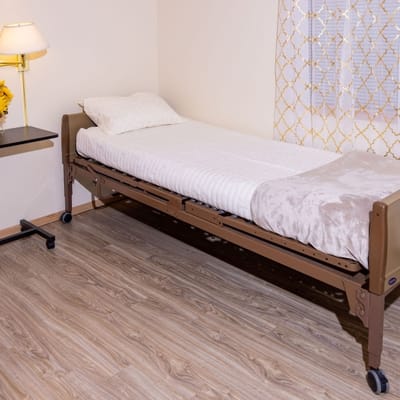 Private resident room with a bed and lamp